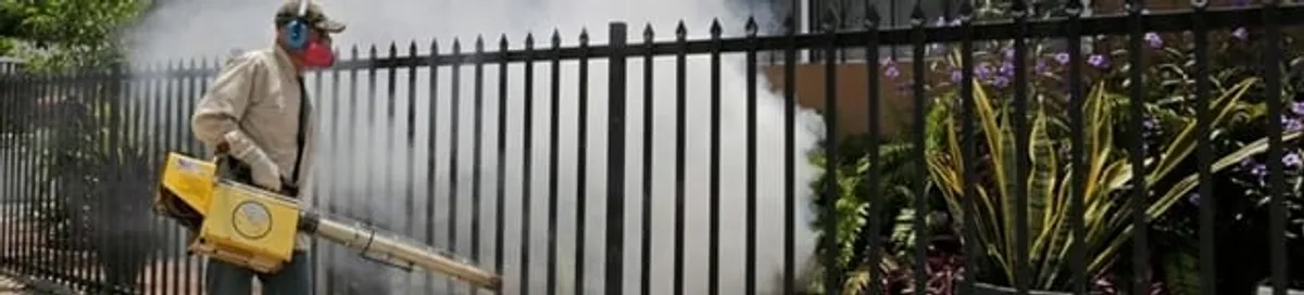 Mosquito control technician fogging a yard perimeter for mosquito reduction in Pasadena, CA